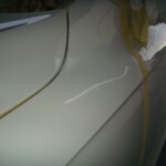 Before and after photographs of a damaged white, AUDI Quattro SUV that was repaired by Elite Paint & Body Shop in West Palm Beach, Florida.